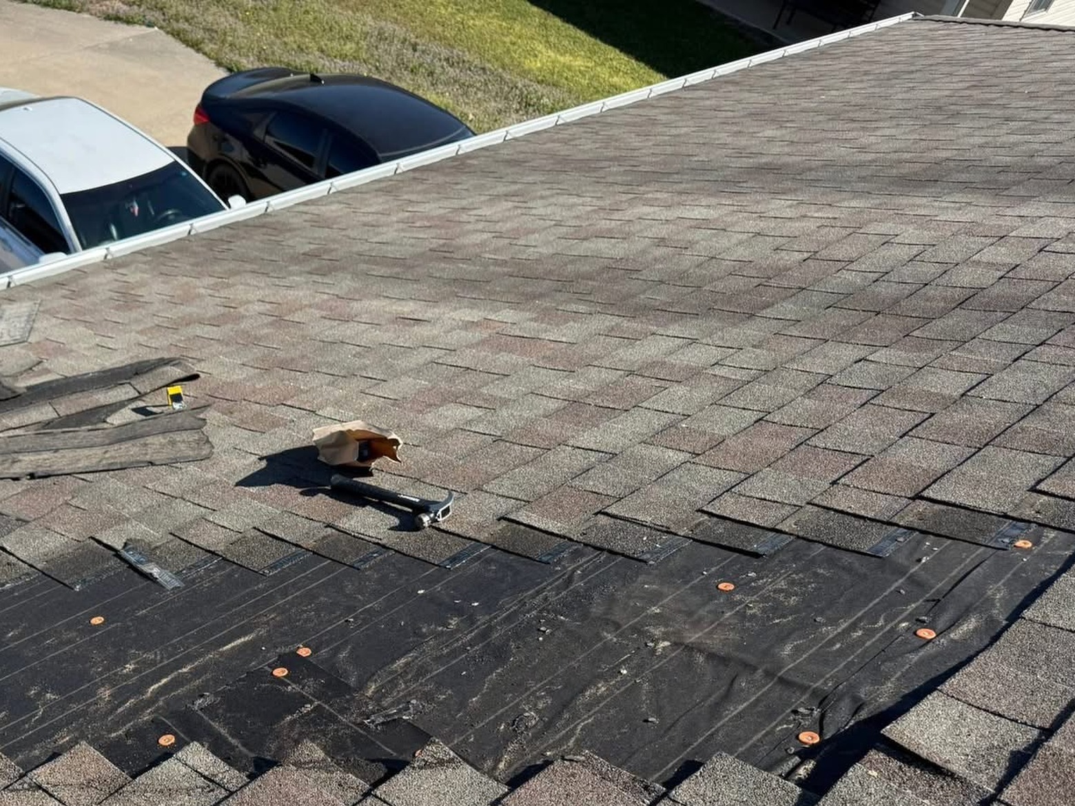 Roof shingle repair before - damaged shingles removed and underlayment exposed