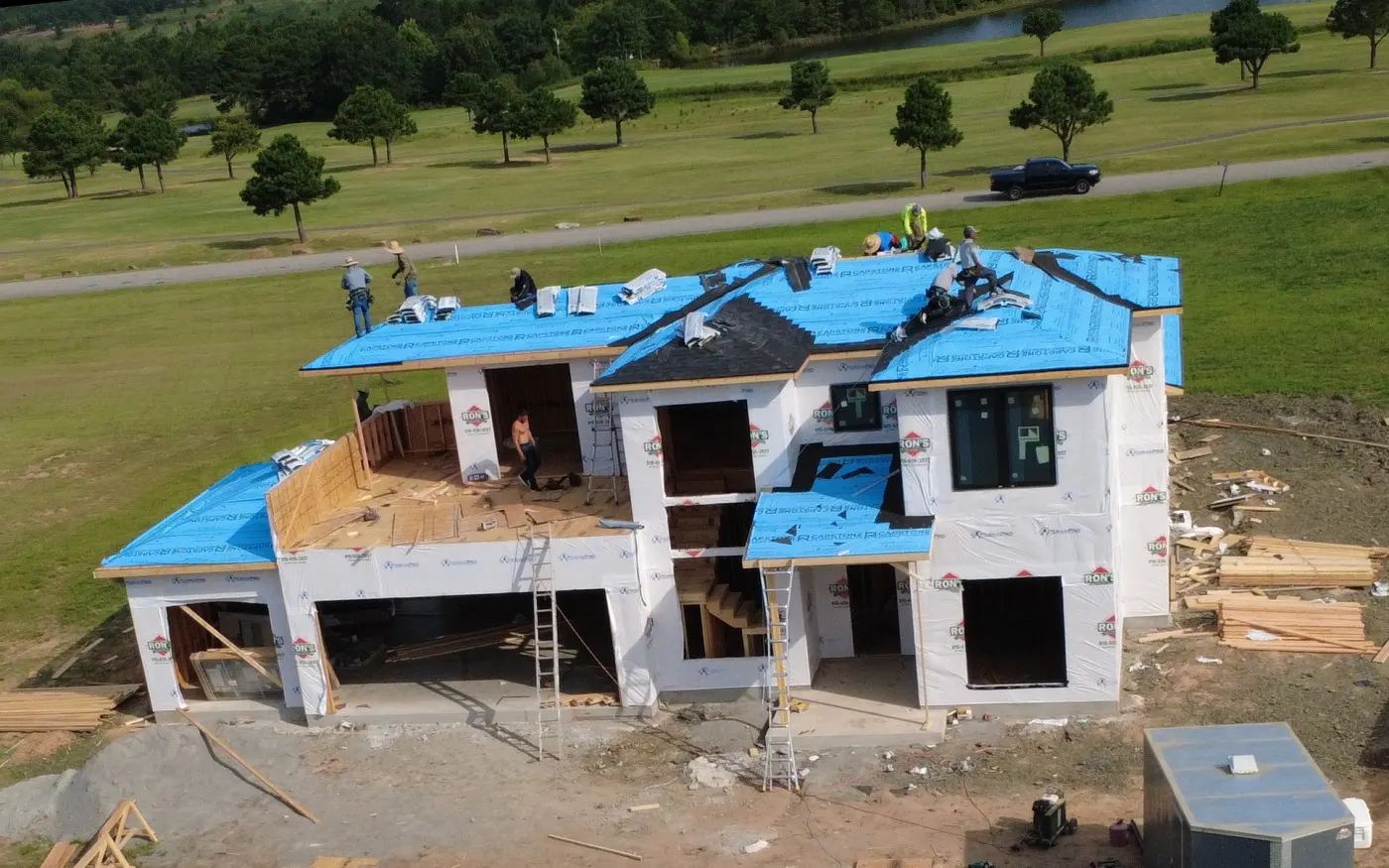New build with roof decking and synthetic underlayment exposed, before shingles