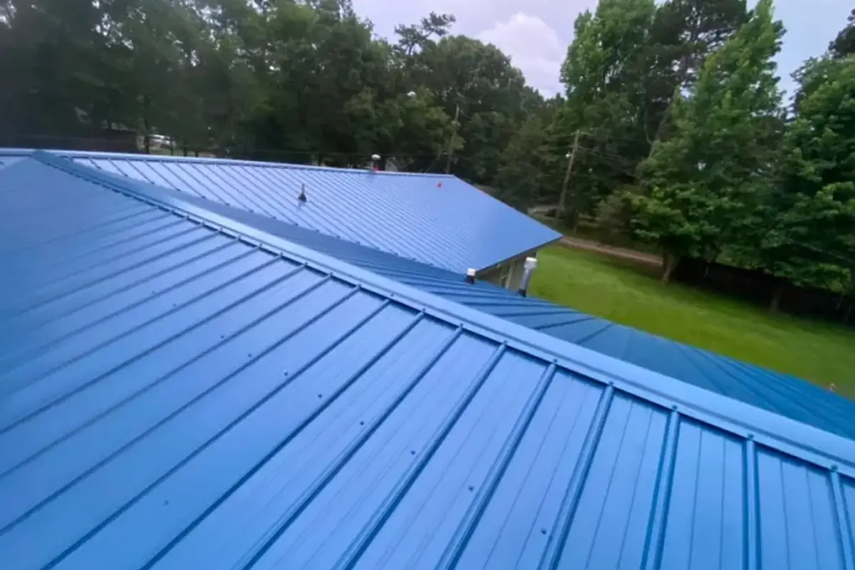 Blue ribbed metal roof panels running down the slope of a house