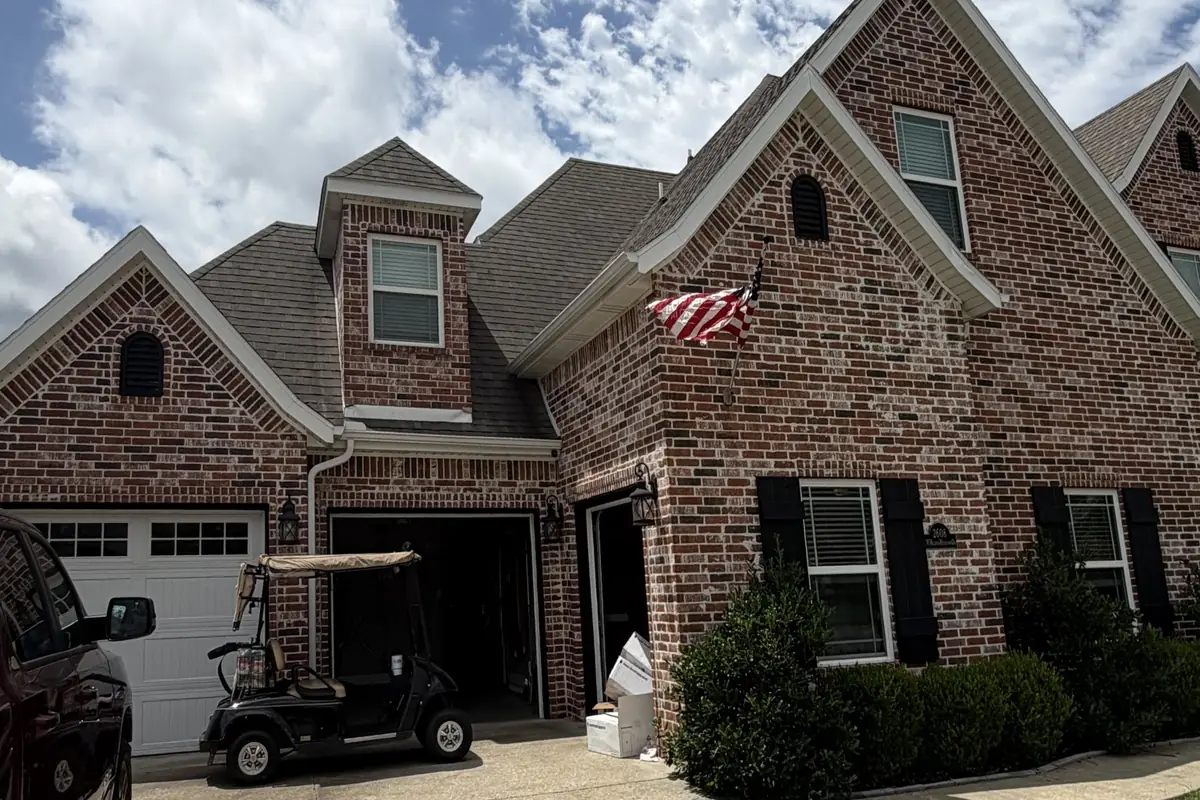 Brick home with its old shingle roof, before replacement