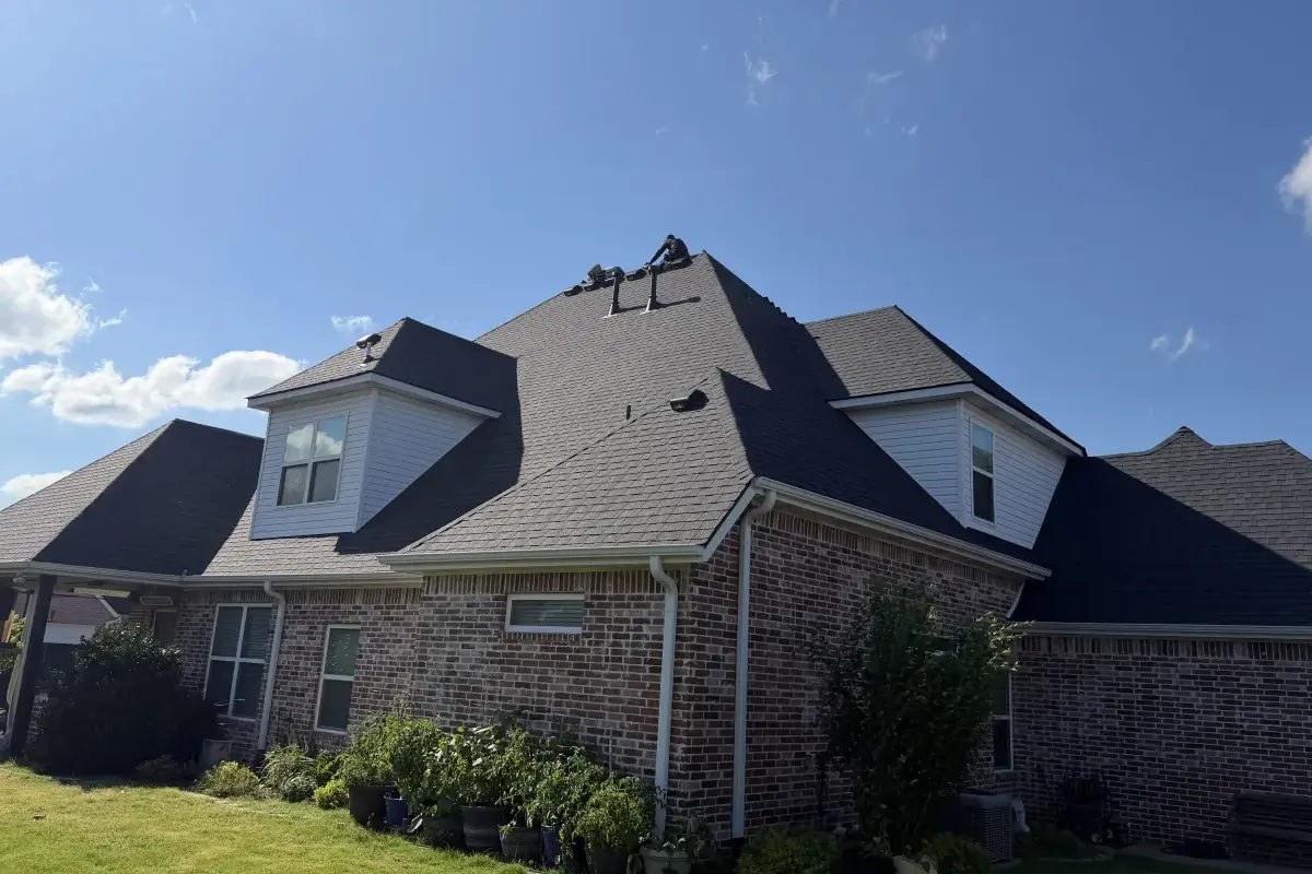 Two-story brick home with a new TAMKO Titan XT shingle roof in Rustic Black