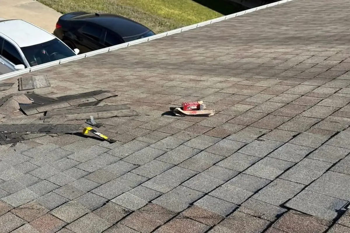 The same section of roof after the repair, with new shingles blended into the old ones