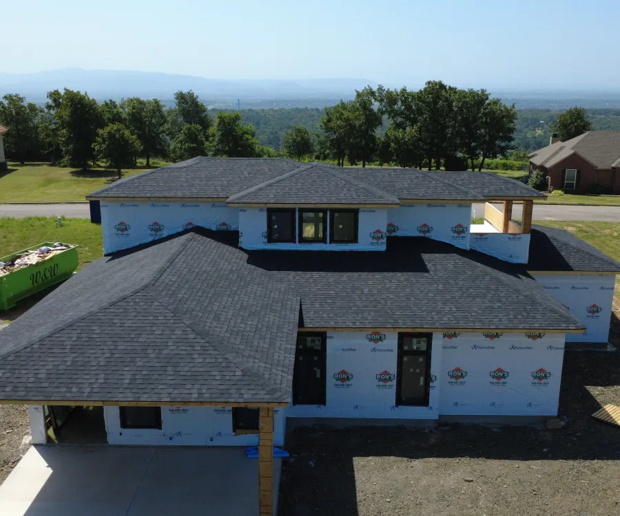 Aerial view of a new build with a freshly installed architectural shingle roof